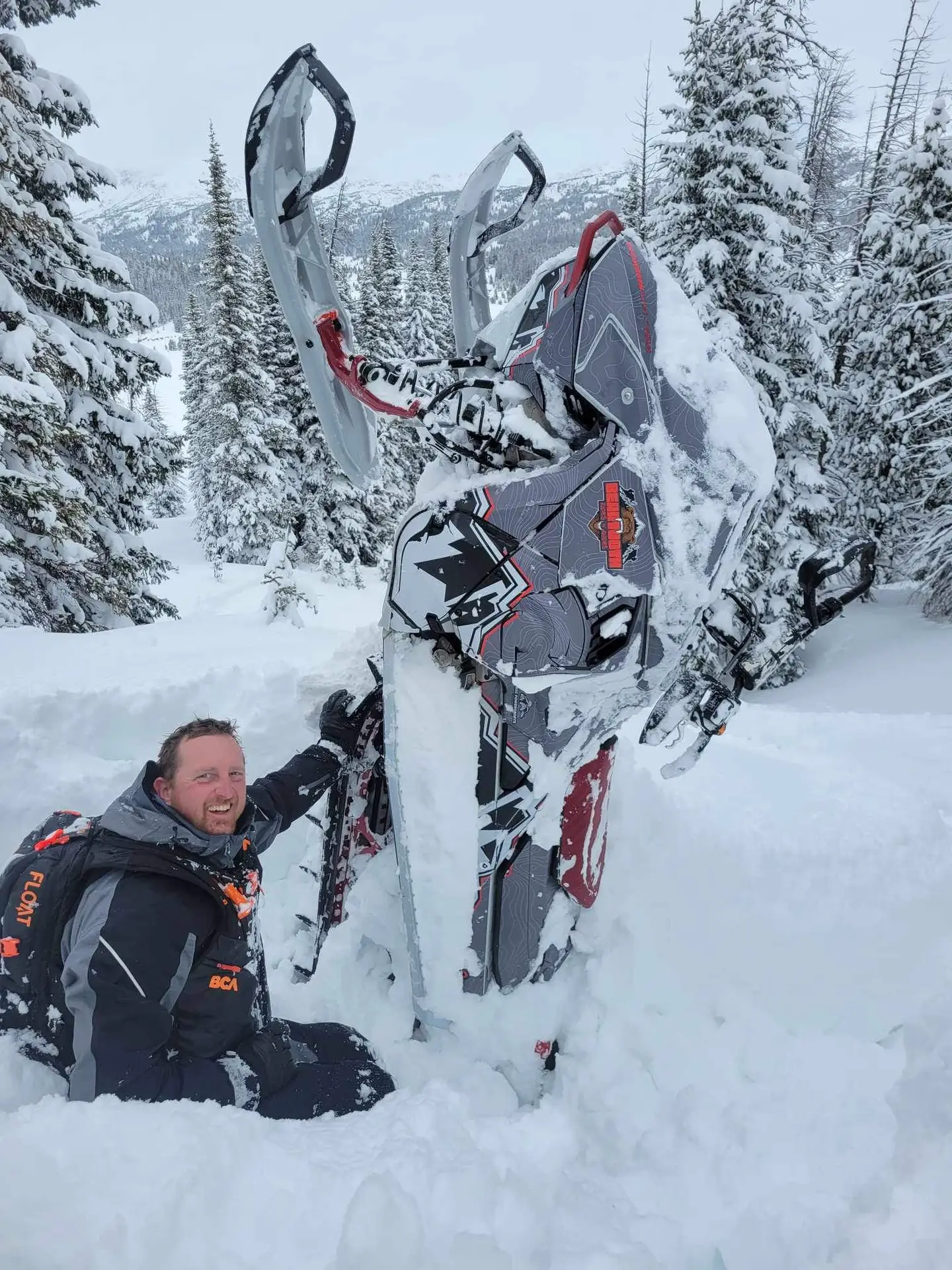 man with stuck sled in snow